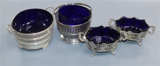 A 1930s pierced silver two handled dish with liner, a silver basket with associated liner and a pair of 800 white metal salts.